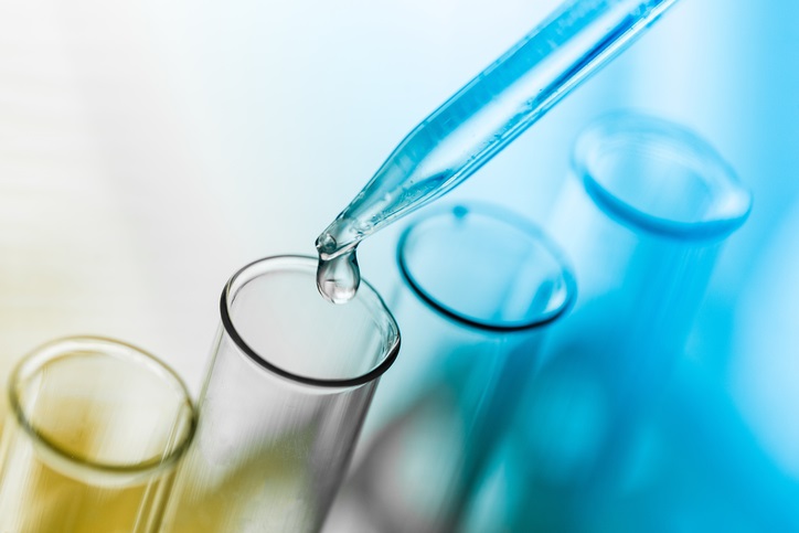 A bunch of test tubes being filled with liquid